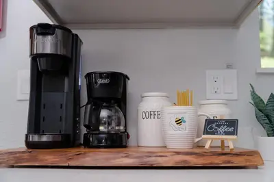 a coffee maker and cups on a wooden shelf at Gorgeous views 1st Apple hill exit Family Fun in Placerville