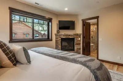a bedroom with a large bed and a fireplace at Mountainside 14 in Mammoth Lakes