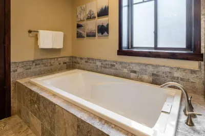 a large tub in a bathroom with a window at Mountainside 14 in Mammoth Lakes