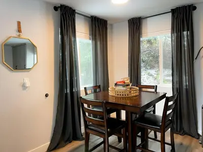 a dining room with a table and chairs and a television at Enjoy the outdoors 1st Apple hill exit Tahoe in Placerville