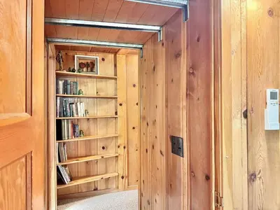 a room with wooden walls and a book shelf at Homestead Ranch near Yosemite with Horses and Chickens in Midpines