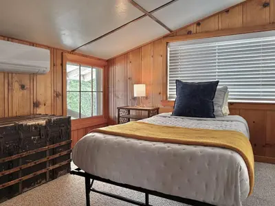 a bedroom with a bed and a window at Homestead Ranch near Yosemite with Horses and Chickens in Midpines