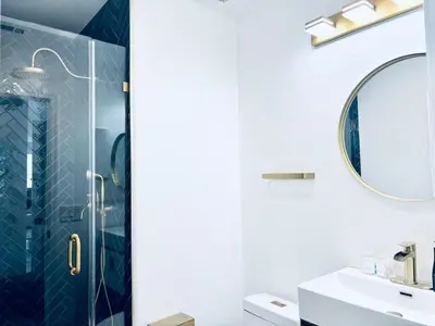 a bathroom with a shower and a sink at Experience Serenity Luxe 4BDR Lake House 25ft Pool in Elk Grove