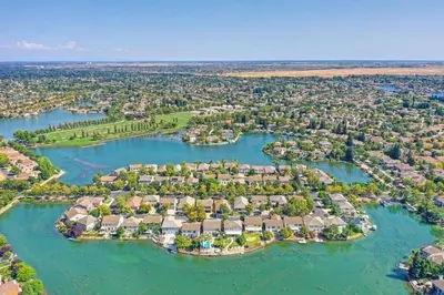 an aerial view of a home on the water at Experience Serenity Luxe 4BDR Lake House 25ft Pool in Elk Grove
