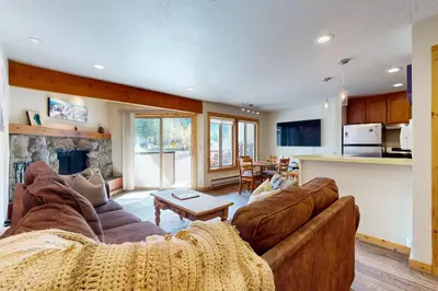 a living room with two couches and a fireplace at Basecamp Bliss in Olympic Valley
