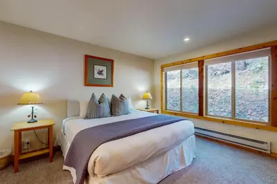 a bedroom with a large bed and a large window at Basecamp Bliss in Olympic Valley