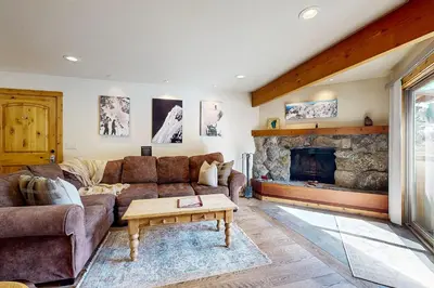 a living room with a couch and a fireplace at Basecamp Bliss in Olympic Valley
