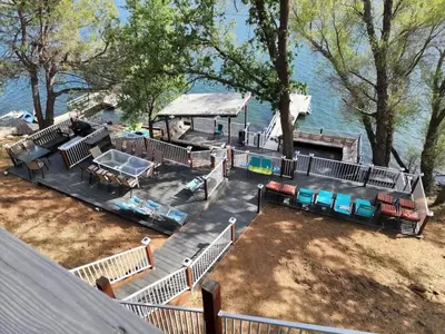 an aerial view of a house with a deck and water at Massive 8 bedroom on the lake in Groveland