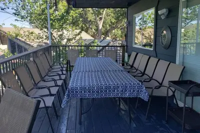 a table and chairs on a porch with a blue and white table cloth at Massive 8 bedroom on the lake in Groveland