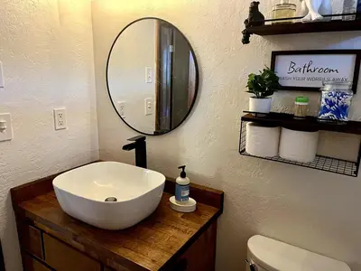 a bathroom with a white sink and a mirror at Private Lakeview Yosemite Full House El Capitan with Panoramic Sauna, Seasonal HotTub, WiFi in Groveland