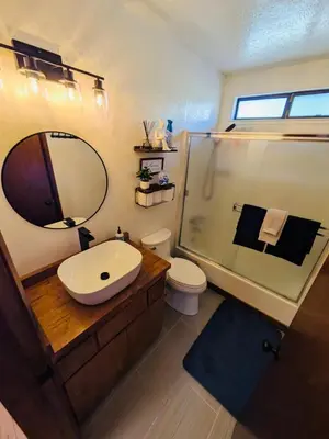 a bathroom with a sink and a shower with a mirror at Private Lakeview Yosemite Full House El Capitan with Panoramic Sauna, Seasonal HotTub, WiFi in Groveland