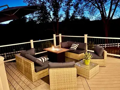 a patio with couches and a table and an umbrella at Pinkie's Suite -Hot Tub-BBQ-views in Ahwahnee