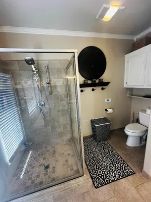 a bathroom with a shower and a toilet at Pinkie's Suite -Hot Tub-BBQ-views in Ahwahnee