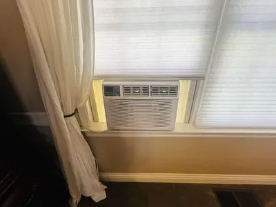 a window with a air conditioner in a room at Pinkie's Suite -Hot Tub-BBQ-views in Ahwahnee