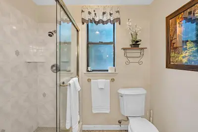 a bathroom with a toilet and a glass shower at Fully Renovated 3Bd at Yosemite's South Gate in Fish Camp