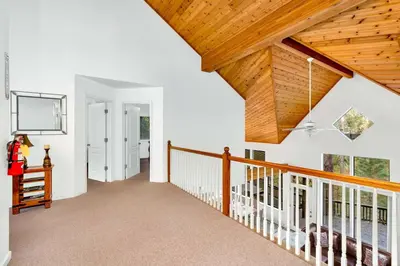 a hallway with white walls and a wooden ceiling at Fully Renovated 3Bd at Yosemite's South Gate in Fish Camp