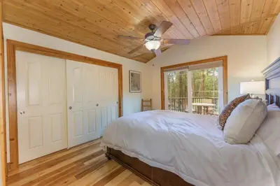 a bedroom with a bed and a ceiling fan at Beautiful 3bd Sanctuary Inside Yosemite in Wawona