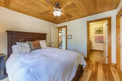 a bedroom with a large bed with a wooden ceiling at Beautiful 3bd Sanctuary Inside Yosemite in Wawona