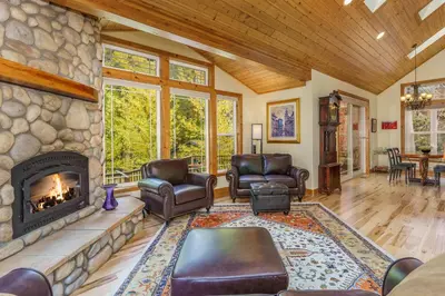 a living room with a fireplace and leather furniture at Beautiful 3bd Sanctuary Inside Yosemite in Wawona