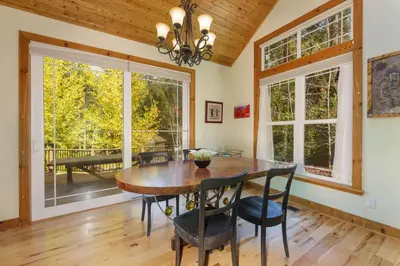 a dining room with a wooden table and chairs at Beautiful 3bd Sanctuary Inside Yosemite in Wawona