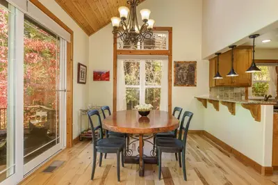 a dining room with a wooden table and chairs at Beautiful 3bd Sanctuary Inside Yosemite in Wawona