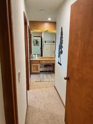 a hallway leading to a bathroom with a sink at Serene Vistas at Northstar in Truckee