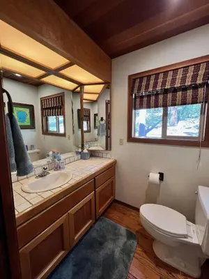 a bathroom with a sink and a toilet and a mirror at Serene Vistas at Northstar in Truckee