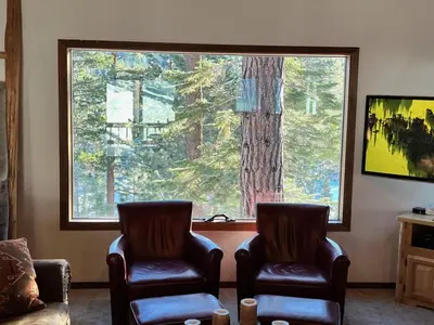 a waiting room with two chairs and a large window at Serene Vistas at Northstar in Truckee
