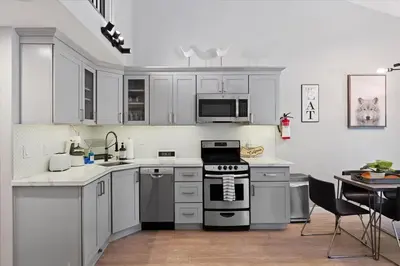 a kitchen with white cabinets and a stove top oven at #LazyBear Tahoe Dreamy Escape in Tahoe Vista
