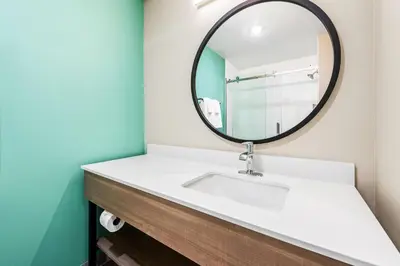 a bathroom with a sink and a mirror at ECHO Suites Extended Stay by Wyndham Reno in Reno