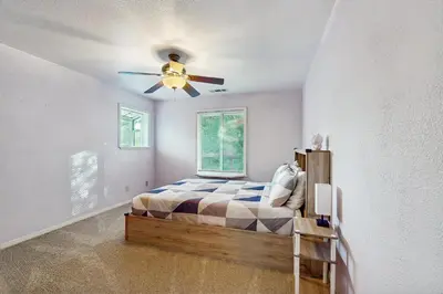 a bedroom with a bed and a ceiling fan at Deer Paradise in Coarsegold