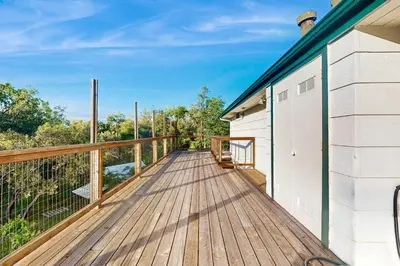 a large wooden deck with a white building at Deer Paradise in Coarsegold