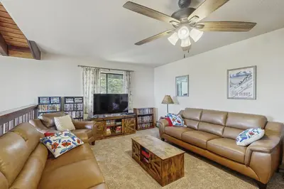 a living room with couches and a flat screen tv at The Garden Haus in Incline Village