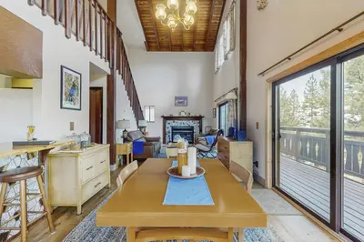 a living room with a table and a fireplace at The Garden Haus in Incline Village