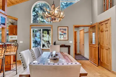 a dining room with a table and a chandelier at Modern Retreat in Truckee with AC and Game Room in Truckee
