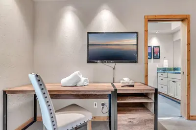a room with a desk with a television and a chair at Modern Retreat in Truckee with AC and Game Room in Truckee