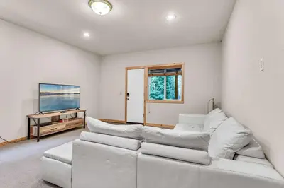 a living room with a white couch and a tv at Modern Retreat in Truckee with AC and Game Room in Truckee