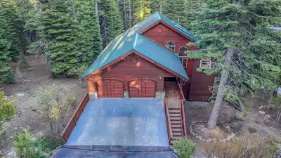 a small house with a swimming pool next to a house at Modern Retreat in Truckee with AC and Game Room in Truckee