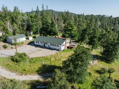 an aerial view of a house in the woods at Yosemite Family Ranch in Oakhurst