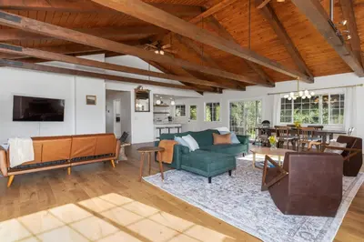 an open living room with a couch and a table at Yosemite Family Ranch in Oakhurst
