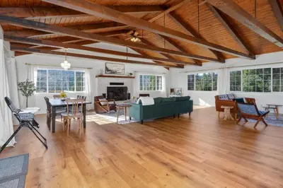 a living room with a green couch and a table at Yosemite Family Ranch in Oakhurst