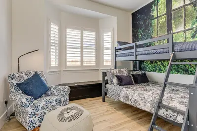 a bedroom with a bunk bed and a chair at 8 Mi to Lodi Lake Luxe Home with On-Site Vineyard in Acampo