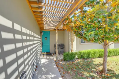 a house with a blue door and a fence at On-Site Vineyard Gem on 10 Acres in Pilot Hill! in Pilot Hill