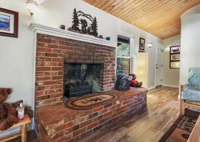 a brick fireplace in a living room at Bear Hollow by Sequoia National Park in Three Rivers