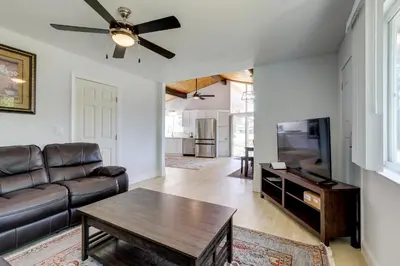 a living room with a couch and a table at 4 Mi to Folsom Lake Modern Home with Patio! in Granite Bay