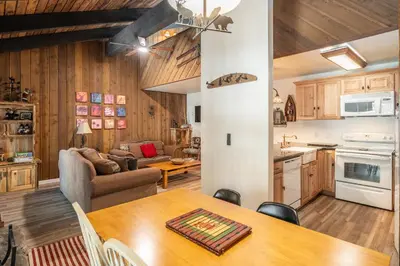a kitchen and living room with a table and a couch at Sunshine Village 120 in Mammoth Lakes