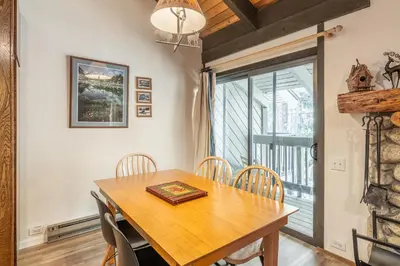 a dining room with a wooden table and chairs at Sunshine Village 120 in Mammoth Lakes