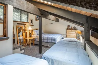 a bedroom with two beds and a desk at Sunshine Village 120 in Mammoth Lakes