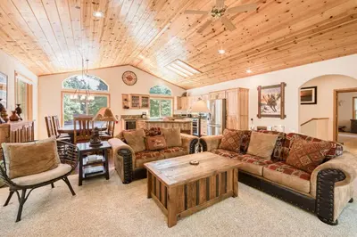 a living room with a couch and a table at Jackpine Lodge at Tahoe Donner by Tahoe Getaways - Private Hot Tub w Foosball and HOA in Truckee