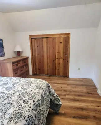 a bedroom with a bed and a wooden floor at Relax Inn - Close to Attractions Galore in Truckee